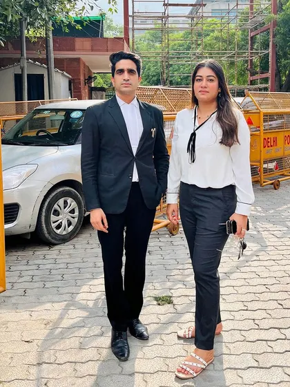 With a colleague outside the court. My primary duty is always protecting my client's rights, and I collaborate with the best to ensure it.
