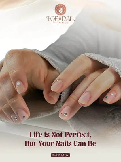 Even simple nail art can make a big impact. This minimalist design features a natural base with delicate dots and strategically placed rhinestones for a touch of sparkle.
