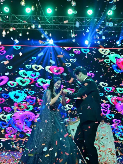 A high-energy couple's dance with a vibrant LED backdrop and confetti blast. This is how you create a sangeet performance that is both romantic and a total party starter.