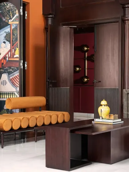 A closer look at the details, where you can see the fusion of styles. A contemporary leather bench sits beside a traditional hand-painted screen, showing how I layer different eras and textures to create a unique, personal narrative.