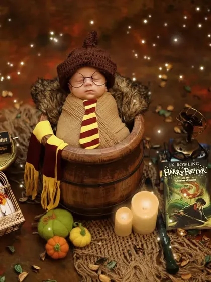 A slightly different angle of the magical newborn setup, showcasing the rich, warm tones and sparkling lights that make these Harry Potter portraits so enchanting.