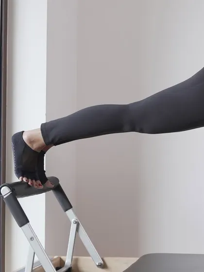 A close up of the feet during a plank on the Reformer. Proper foot placement is crucial for maintaining alignment and engaging the correct muscles throughout the body.