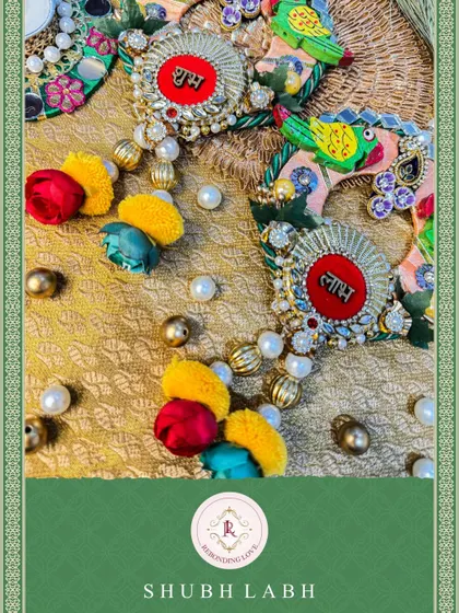 A close-up of our parrot-themed Shubh Laabh hangings. The colorful pom-poms and pearl details add a playful and traditional touch to your doorway.