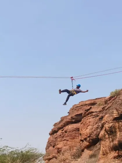 Adventure extends beyond climbing. A participant enjoys a thrilling zipline ride across a canyon during our Badami course, a fun way to experience the landscape.