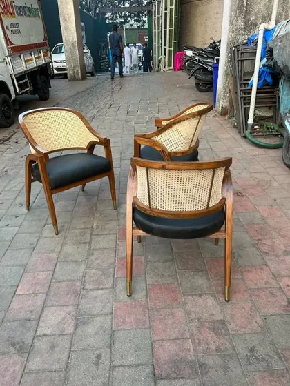Another shot of the three chairs, highlighting their sturdy teak construction.