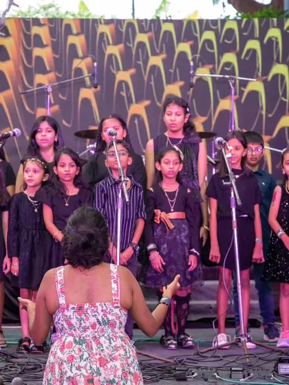 Our junior choir being led by their instructor on stage. These performances are a proud moment for students, parents, and teachers alike.