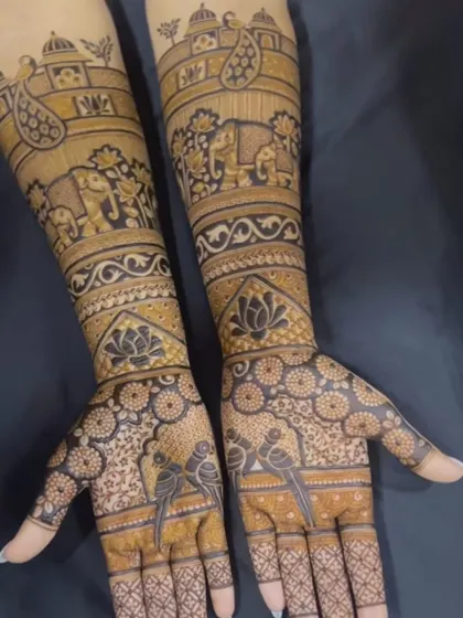 This design is like a storybook on the arms, with elephants, birds, and paisley motifs. The palms feature parrots, symbolizing love and passion.