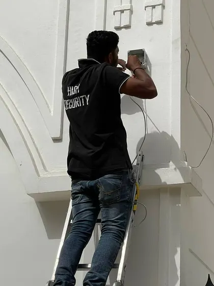 Preparing the mounting point for an outdoor camera. I ensure every base is securely fixed to the wall before attaching the camera.
