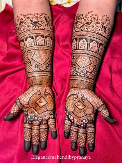This engagement mehendi has the couple's names, Shreya and Ravi, hidden within the geometric patterns on the forearms.