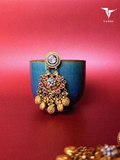 Lotus motifs, pearls, and meenakari craftsmanship come together in these earrings, creating a timeless piece that celebrates tradition with a modern twist. The gold accents add just the right amount of drama.