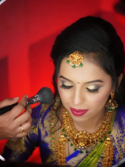 The final powder touch-up. Using a ring light helps me see every detail, ensuring the makeup is perfectly blended and set to last all day and night.