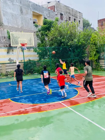 A shot goes up towards the hoop on a cloudy, rainy day.