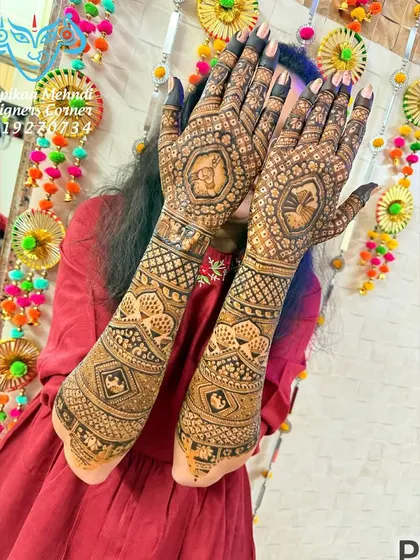 The same beautiful bride, showing the full view of her traditional mehndi. The design is rich and detailed, perfect for a grand bridal look.