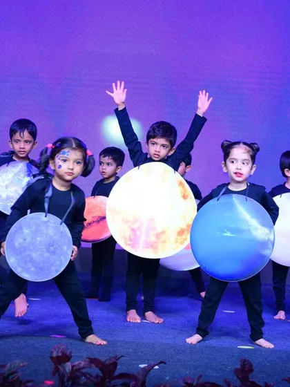 The "planets" dance on stage, each child representing a different celestial body. Our Annual Day themes are educational and creatively executed.