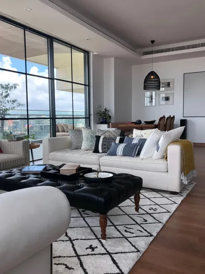 The living room in Parineeti Chopra's apartment, with its stunning city view. We used a neutral palette with comfortable, modern furniture to create a serene and sophisticated space that doesn't compete with the skyline.