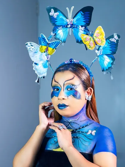 Another angle of the butterfly fantasy look, emphasizing the delicate details and the cohesive blend of face paint, accessories, and expression.