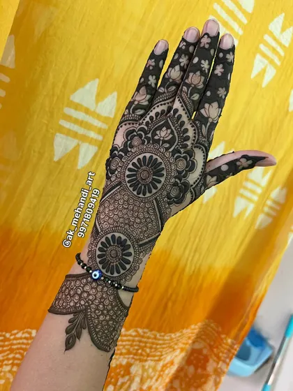 A beautiful back-hand design for Teej, featuring lotus motifs and delicate dot work.