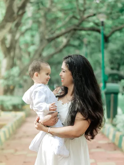 A beautiful, candid shot of a mother and son looking at each other with love. Our outdoor sessions are perfect for capturing these unposed, heartfelt connections in a natural environment.