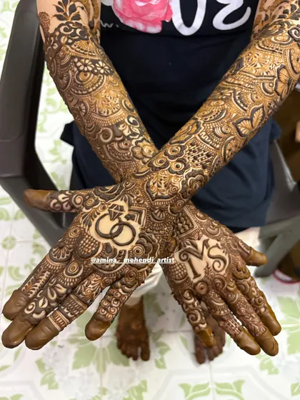 An engagement mehendi design to celebrate your special day. This look features the couple's initials and a prominent ring motif on the palm, surrounded by my favorite floral and paisley patterns that extend up the arm.