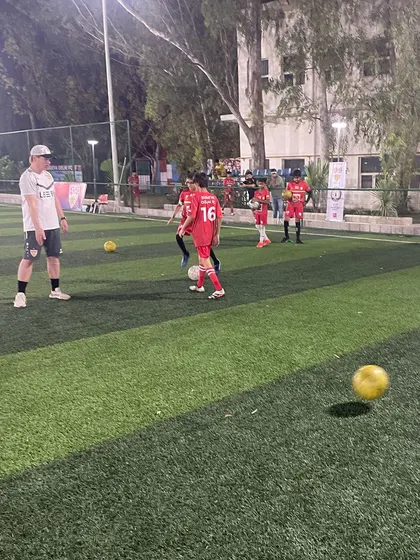 A player controls a moving ball during a drill. First touch and control are fundamental skills that we emphasize in every training session.