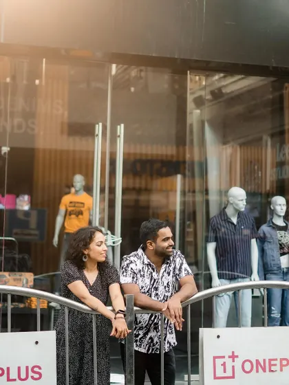 A candid shot of the couple observing the city life around them during their urban pre-wedding shoot.