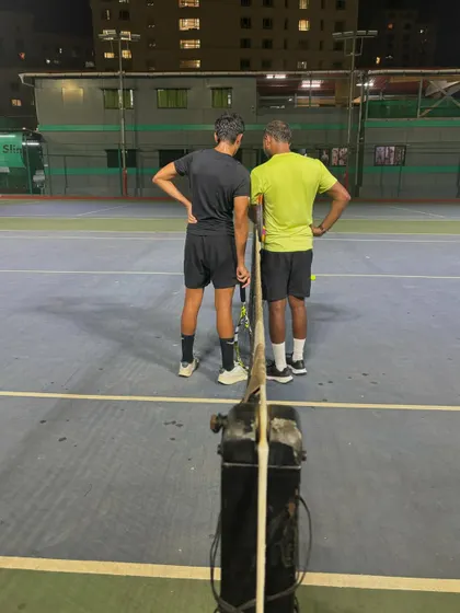 A moment between coach and student to discuss strategy and technique. This personalized feedback is crucial for player development.