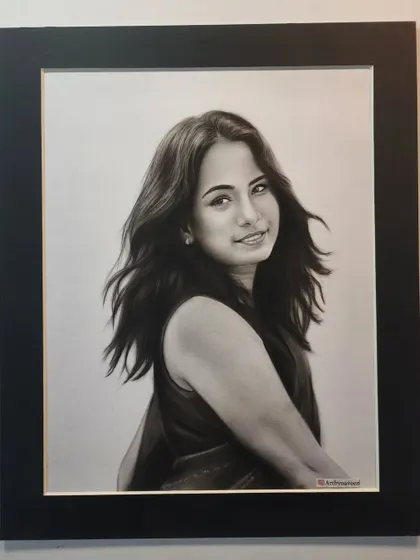 The finished portrait in a black frame.