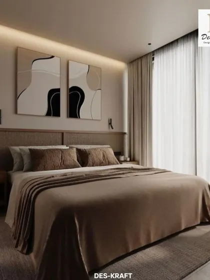 The bed is framed by a low, upholstered headboard and abstract art, with soft backlighting creating a gentle, relaxing glow.