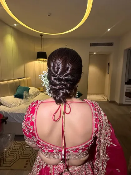 This is a beautiful example of a textured, woven low bun. I teach my students how to create these intricate patterns and pull-outs to give the illusion of thicker, more voluminous hair in an updo.