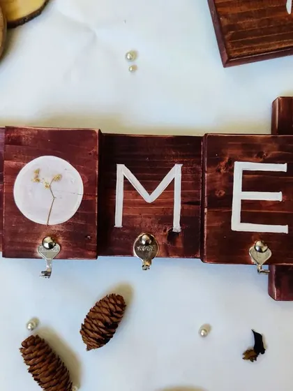 Our latest keyholder design, spelling out "HOME" on separate wooden blocks. This modular design adds a rustic and personalized touch to your entryway.