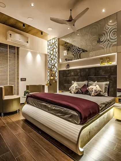 A contemporary bedroom design with a unique curved bed frame and integrated under-bed lighting. The headboard wall features etched glass panels and a decorative laser-cut screen.