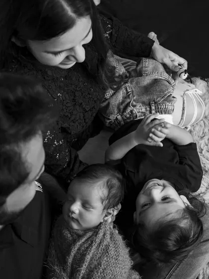 A bird's-eye view of family love. This black and white photo shows a family of four sharing a quiet, connected moment.