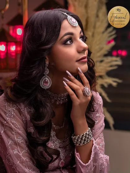 A detailed close-up focusing on the jewelry and side profile. This type of shot is crucial for showcasing the work of makeup artists and jewelry designers.