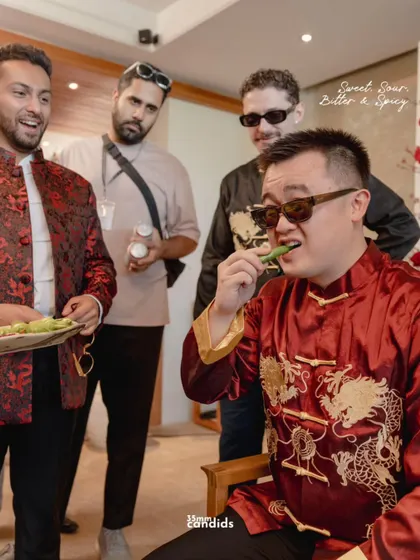 The groom's friends continue with the spice test, a hilarious and memorable part of the Chinese door games. Capturing the reactions is key to telling this part of the story.