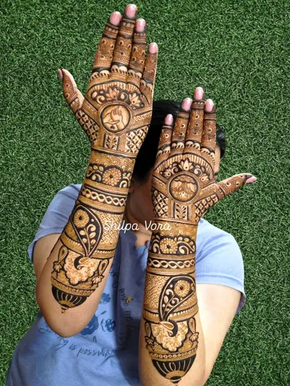 Full coverage bridal mehndi for a client, featuring elephants and paisleys. This design extends up to the elbow for a complete bridal look.
