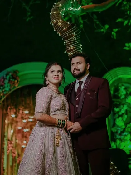 A grand reception shot of the couple standing under a beautifully lit tree, a perfect end to a perfect day.