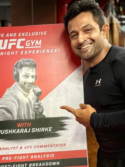 Pointing to the poster for my live analysis event at UFC Gym. It's great to see the community come together.