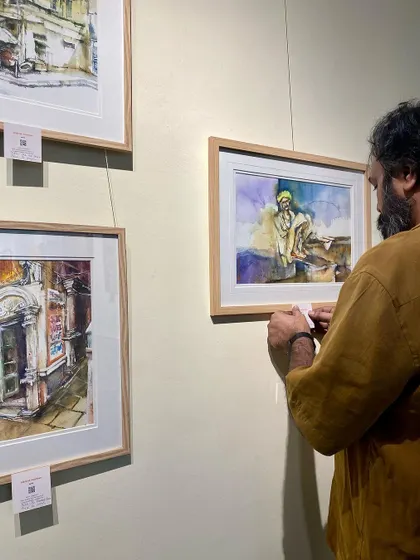 A candid moment of my husband helping set up the paintings at the exhibition. It truly takes a village.