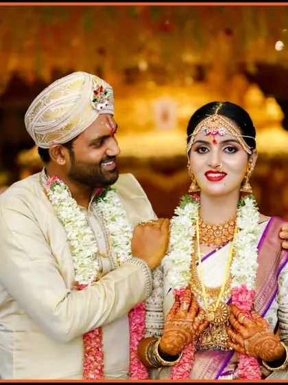 An elegant portrait of the couple on their wedding day. The groom's hand on the bride's shoulder and their happy expressions convey a sense of partnership and joy.