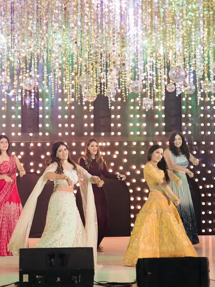 This wide shot shows the entire bride squad in action under beautiful cascading lights. I help plan the use of the stage to make sure every group performance looks grand and well-rehearsed.