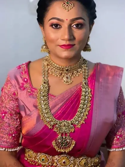 A close-up of a bride's muhurtham look, featuring a beautiful antique-finish choker and haram set.