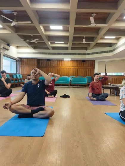 Here, students engage in Nadi Shodhana, or alternate nostril breathing. This fundamental pranayama technique is taught in my classes to purify the energy channels, balance the left and right hemispheres of the brain, and create a state of tranquility.