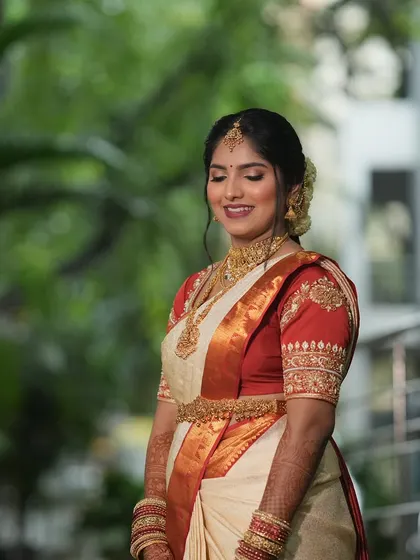 A candid moment of joy. For Vindya's Muhurtham, I created a soft, glowing makeup look that perfectly matched her beautiful off white and red silk saree.