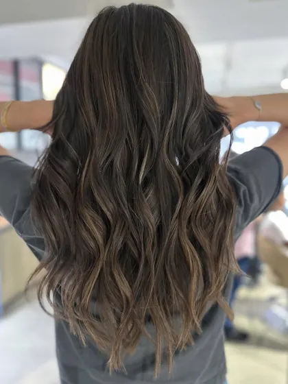 This is a great example of a cool-tone balayage transformation. The result is a sophisticated and modern look, perfect for getting your hair summer-ready.