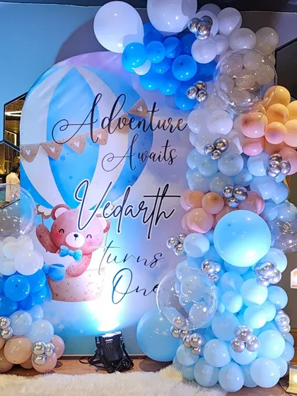 The lighting makes all the difference! Here you can see how a simple spotlight enhances the colors and details of the first birthday backdrop, making it pop for photos.
