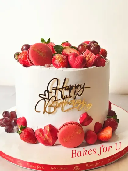 This vibrant birthday cake shows how I love to play with color using natural elements. The design features fresh strawberries, ruby chocolate hearts, and delicate macarons, all arranged on a smooth, white buttercream canvas.