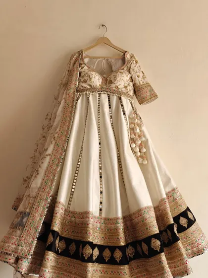 A new arrival in our collection. This white lehenga features beautiful floral embroidery and mirror work, perfect for a bridesmaid or for a pre-wedding event.