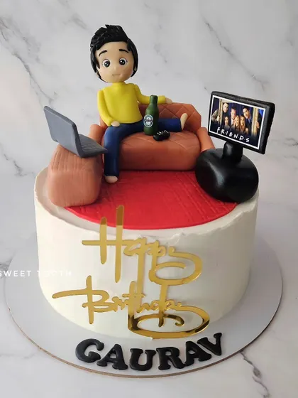 The Lazy Lad. A chocolate truffle cake for Gaurav's birthday, showing him chilling on the couch watching 'Friends' with a beer and his laptop.