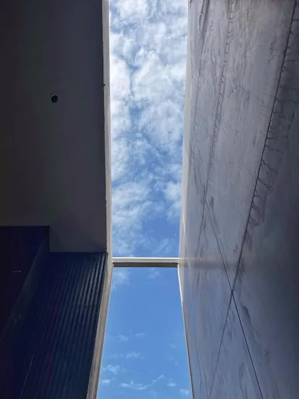 Looking up through a skylight during construction. These openings are essential for bringing natural light into the core of a building, which is a key principle in our design approach.
