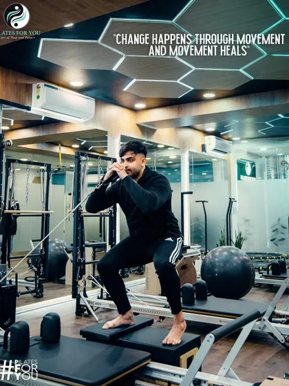 Movement heals. This client is performing a squat on the Reformer, a low-impact exercise that builds strength without stressing the joints. It's perfect for rehabilitation and general fitness.